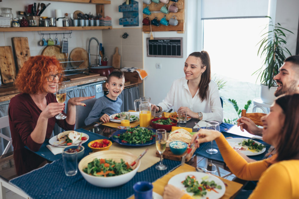 Family eating a meal around the table at home