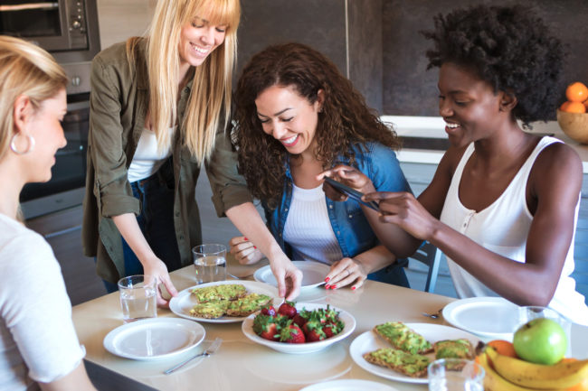 Four friends eating healthy food