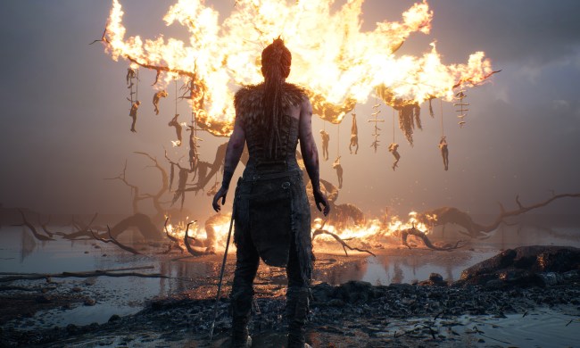 Senua stares at a burning tree in Hellblade 2.