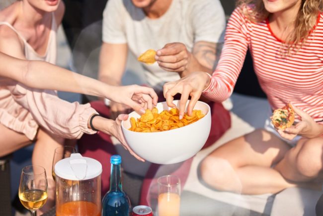 People sharing snacks, chips, snacking, picnic